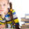 Portrait of surprised girl  reading books on isolated white background